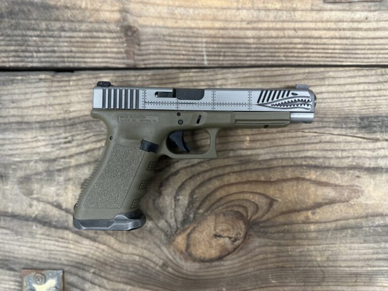Glock 34, 9mm Luger, 10+1, 5.31″ Black Barrel, Custom “P40 Warhawk” Style Slide, Green Polymer Lower Grip Assembly, Brushed Metal Flared Magwell, OEM Case